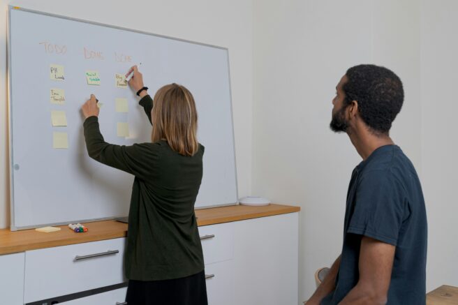 Product Managers Writing On A Whiteboard