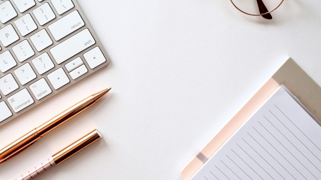 A Mac Keyboard And Pens With A Piece Of Paper Denoting Someone About To Write A Cv